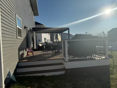 Side angle of the Carver composite deck showing the covered seating area and railing layout