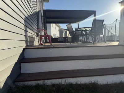 Wide composite deck stairs on the Carver project showing clean risers and finished stair access to the yard