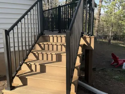 Composite deck stairs with black aluminum railings in Chanhassen