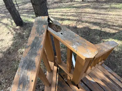 Close view of worn and damaged wood railing on Chanhassen deck project