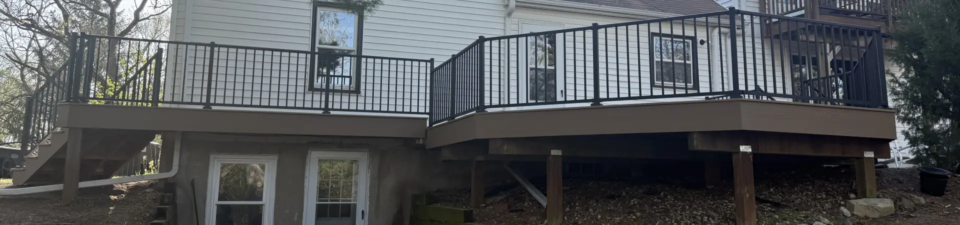 Chanhassen composite deck replacement with black aluminum railings and stairs