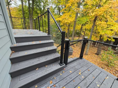 Short flight of gray steps connecting the deck and lower landing