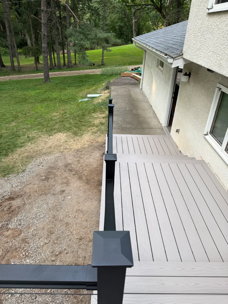 Upper Cottage Grove deck level with light composite boards and black railing posts
