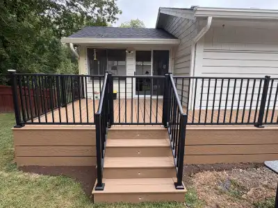 Front view of Deephaven deck stairs with black railings and finished brown fascia
