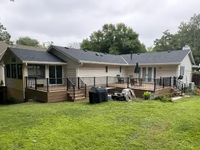 Wide view of completed Deephaven backyard deck spanning the rear of the home