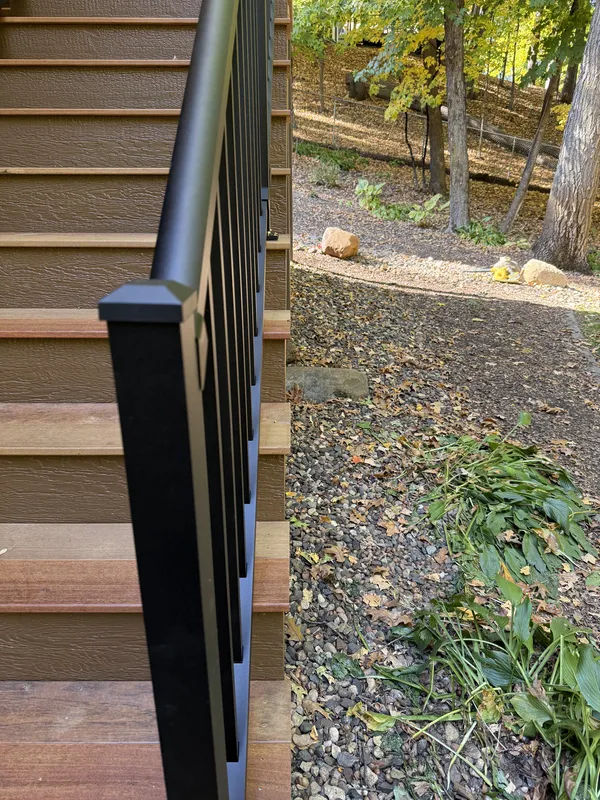 Black railing post and balusters beside the deck stairs