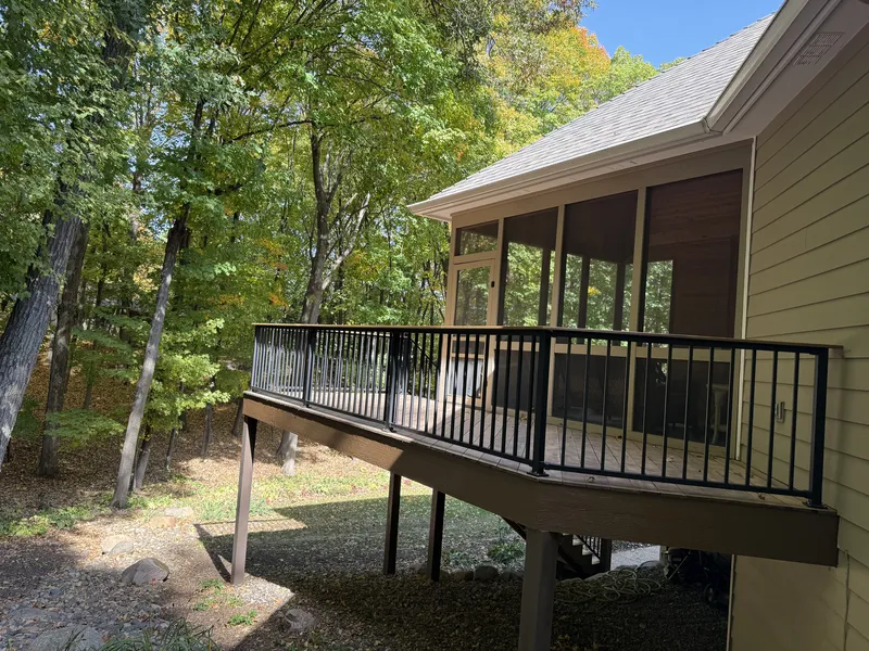 Deephaven deck viewed from the wooded yard beside the screened porch