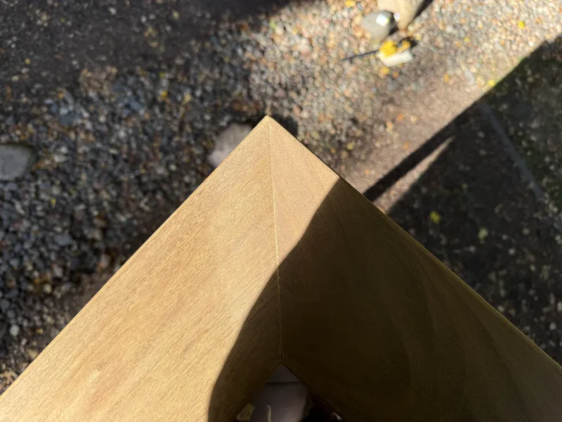 Mitered corner in the wide brown deck railing cap