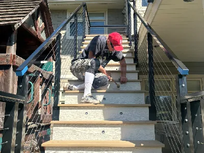 Danny finishing composite deck stair risers on an Edina deck resurfacing project