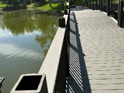 Bridge railing installation with new posts and finished deck surface in Hopkins