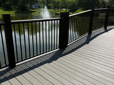 Bridge railing installation with new posts and finished deck surface in Hopkins