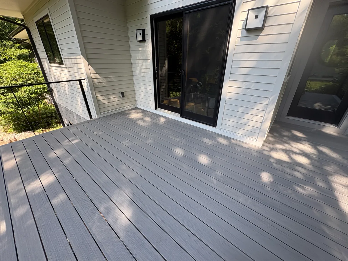 Hopkins composite deck project with gray decking, black cable railings, and wide stair transitions.