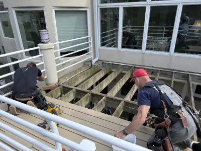 Crew working around exposed deck framing during the Hopkins resurfacing project