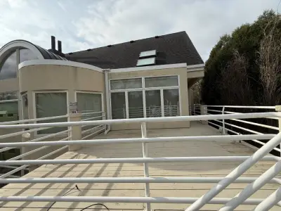 Before view of the upper deck area with older deck boards and white railings