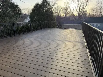 Close-up view along a black aluminum deck railing on a Minneapolis rooftop garage deck