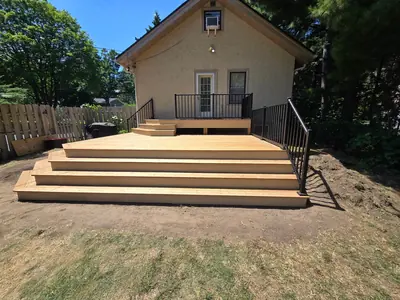 Front view of Minneapolis wood deck with broad stairs leading into the backyard