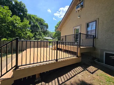 Wood decking and black aluminum railings on a Minneapolis backyard deck