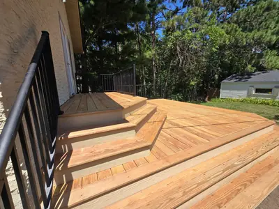 Multi-level Minneapolis wood deck showing the upper landing and lower platform