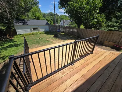 Black aluminum railing overlooking a new wood deck and backyard in Minneapolis
