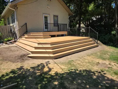 Wide wraparound wood stairs on completed Minneapolis deck project