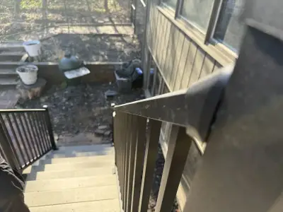 View down the new composite deck stairs with black aluminum railings in Minnetonka