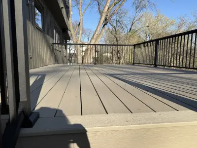 Composite deck surface in Minnetonka with black aluminum railings around the perimeter