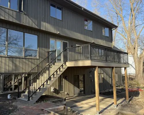 Minnetonka composite deck project with new doorway, stairs, and black aluminum railings by Brewer Built