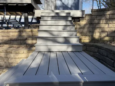 Composite deck resurfacing progress with new boards installed on the main deck