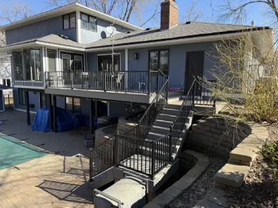 Wide finished view of the resurfaced deck and rebuilt stair system in Minnetonka