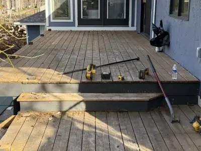 Partially demolished deck showing the worn surface before new materials were installed