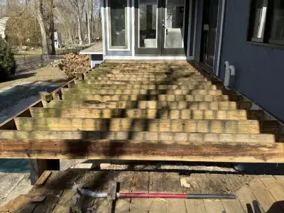 Open deck framing and exposed stair area during demolition in Minnetonka