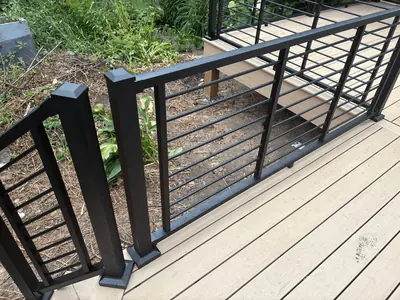 Close view of black horizontal railing on tan composite deck in Minnetonka