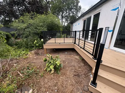 Exterior view of Minnetonka composite deck with black railings and stairs