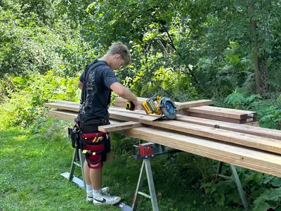 Brewer Built crew cutting framing lumber for Minnetonka under-deck project