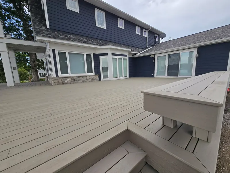Wide composite deck across the back of a Minnetrista lakeside home