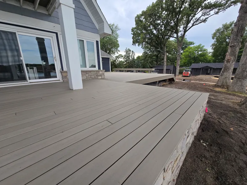 Large composite deck platform and stone edge on a Minnetrista home