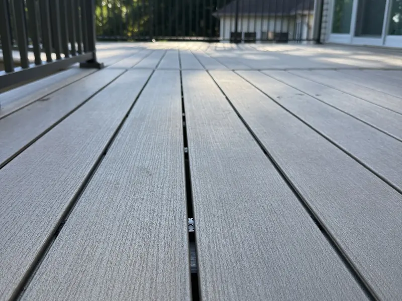 Close view of warm-toned composite deck boards on the Savage deck project