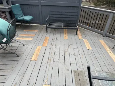 Older deck boards with wood replacement patches during a St. Louis Park deck repair