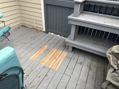 Deck board replacement work near stairs on a St. Louis Park deck repair project