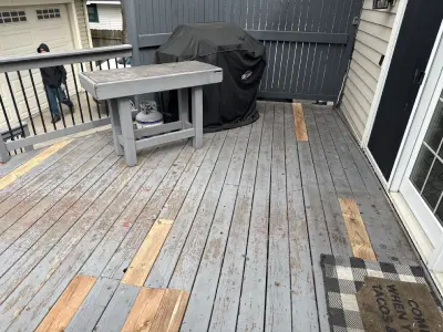 Deck surface repair with replacement wood boards on a St. Louis Park backyard deck