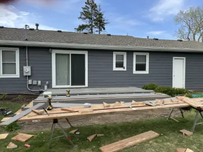 Finished gray composite deck with white railing and new stair access in Wayzata