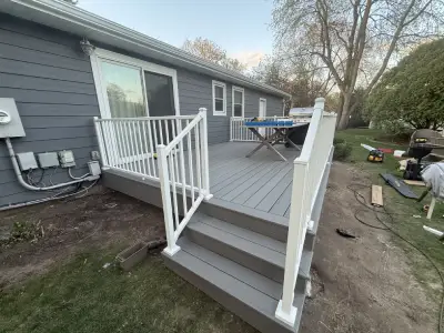 Completed Wayzata deck with white railings and gray composite decking