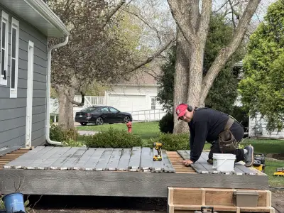 Deck resurfacing progress with exposed framing and new composite boards