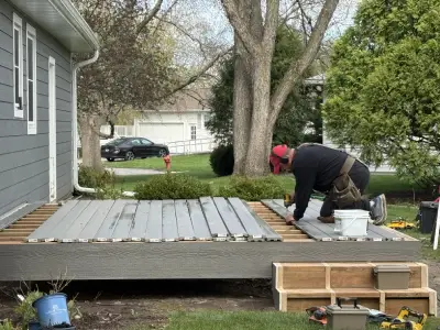 Lead carpenter installing composite decking during a Wayzata deck project