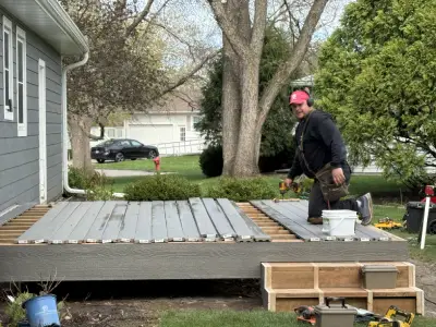 Composite deck installation progress with tools and trim boards on site