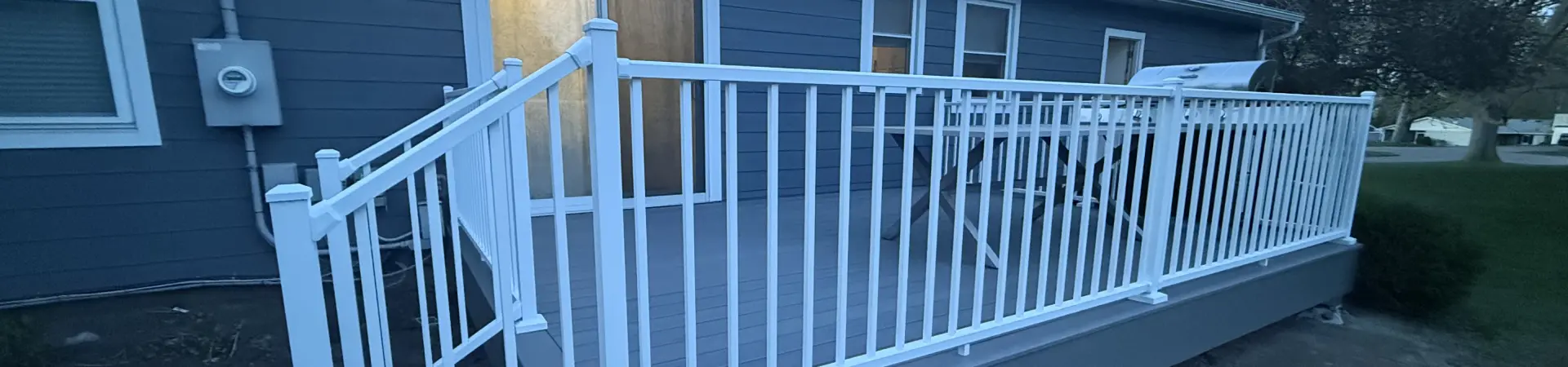 Completed Wayzata deck resurfacing project with gray composite decking and white railings