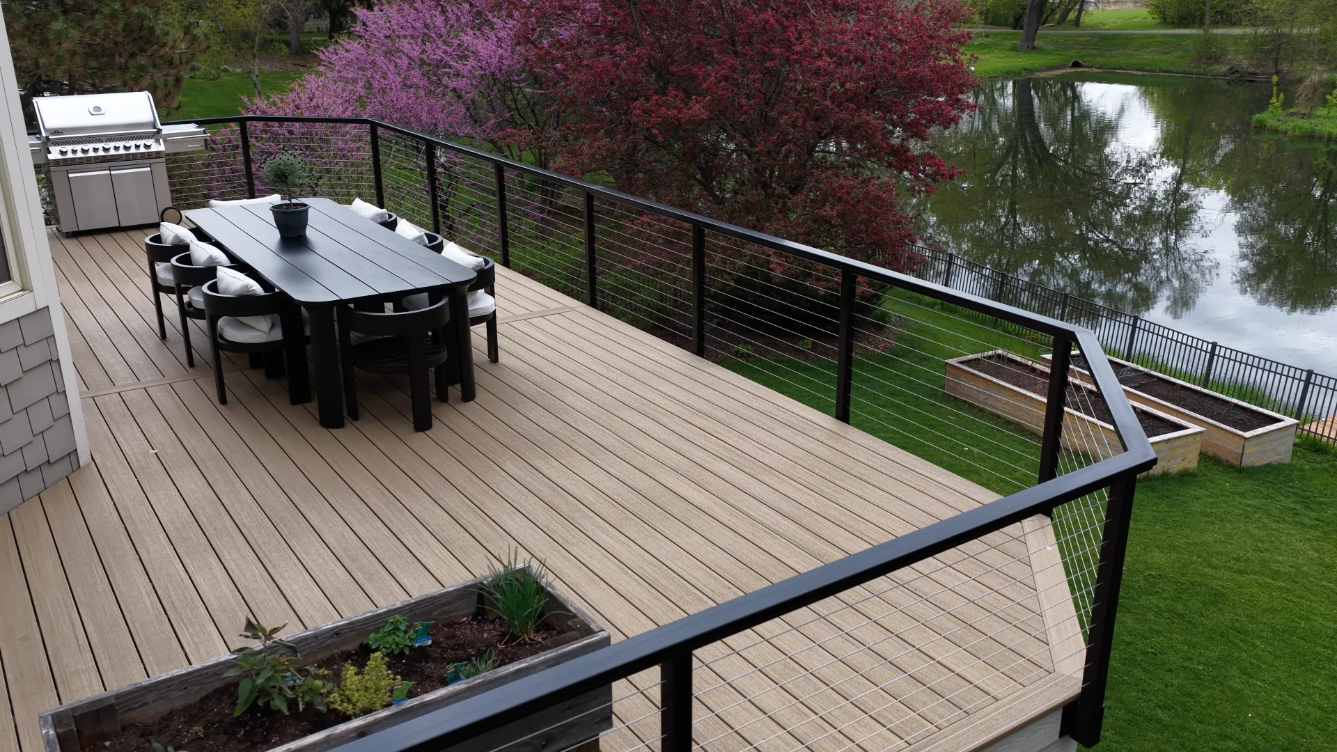 Custom composite deck with wide steps and black aluminum railings