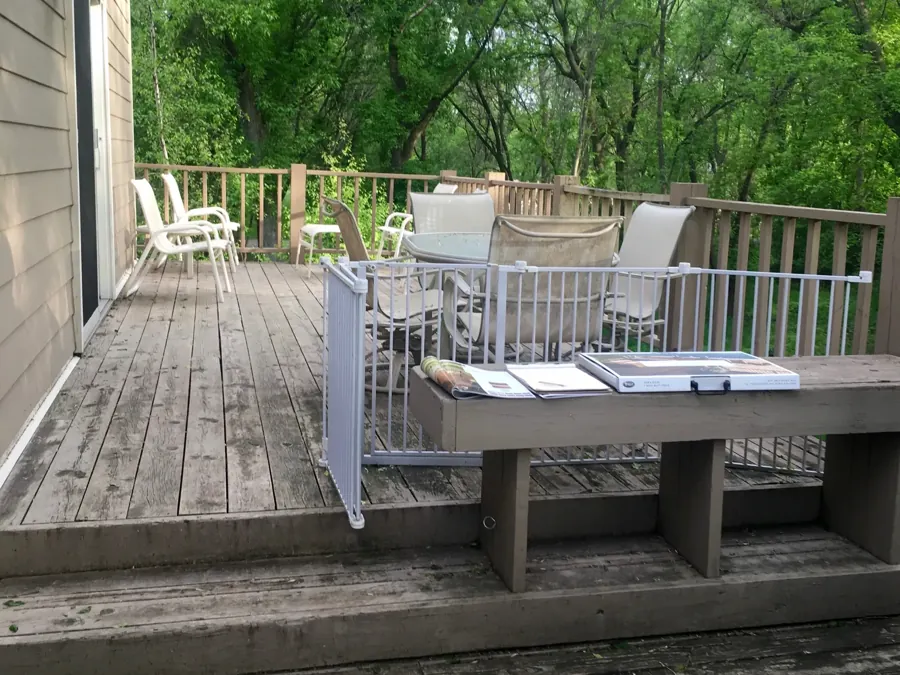 Weathered deck boards and steps beside the home before construction