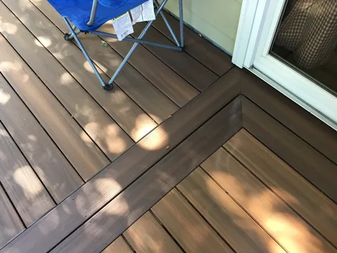 Close-up of composite deck board border detail near a sliding door