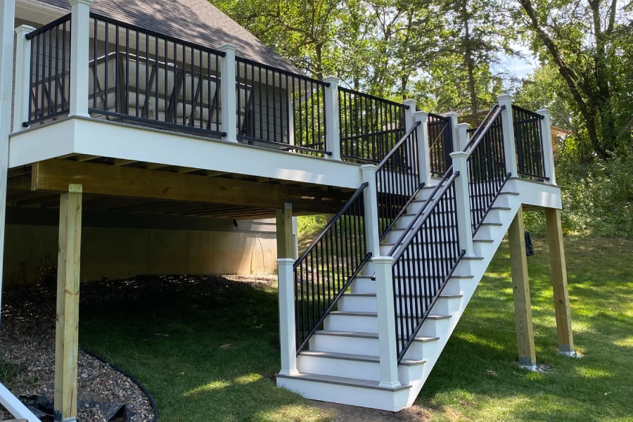 Raised backyard deck with black railings and stair access